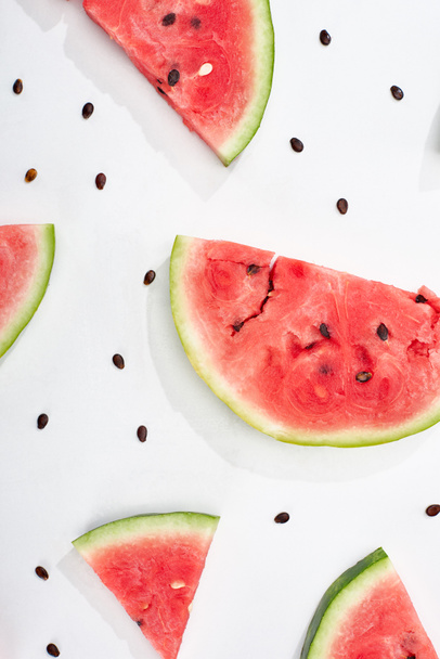 top view of delicious watermelon slices with seeds on white background - Fotoğraf, Görsel