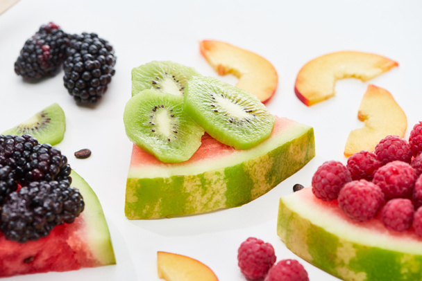 delicious dessert with watermelon, kiwi and berries on white background - Foto, Imagem