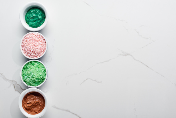 top view of color bath salts and natural mask on marble surface - Fotografie, Obrázek