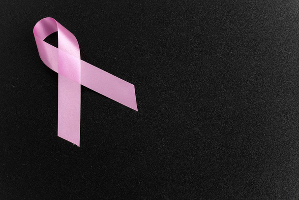 pink aids ribbon on black background  - Foto, imagen