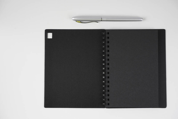 black cover paper textbook diary and pen  - Fotó, kép