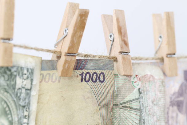 Money Laundry concept, hanging paper money on clothesline - Fotó, kép
