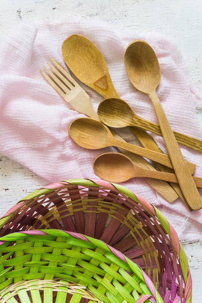 Wooden spoons and wicker baskets and white vintage background. Flat lay, top view, copy space. - Foto, Bild
