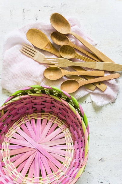 Wooden spoons and wicker baskets and white vintage background. Flat lay, top view, copy space. - Foto, Bild
