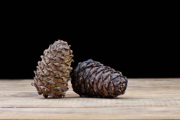 Siberian taiga cedar cones on a wooden table. Cedar resin on a bump - Φωτογραφία, εικόνα