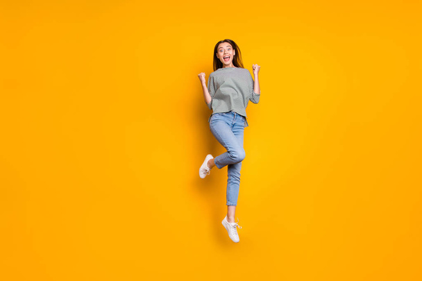 Full length body size photo of slim slender thin beautiful girl wearing jeans denim trousers isolated with yellow background - Foto, immagini