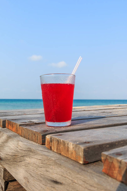 Strawberry juice on Wooden pathway near the beach - Фото, зображення