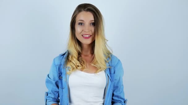 young beautiful sexy blonde woman smiling rising and waving her hand on isolated white background - Metraje, vídeo