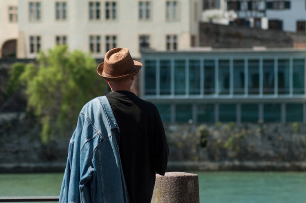 hombre con sombrero de verano mirando el río Rin en Basilea Suiza
  - Foto, Imagen