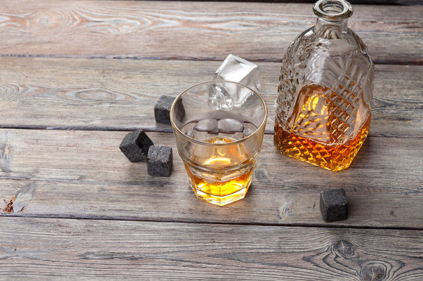Whiskey beverage in glass with stone. Alcohol background - Zdjęcie, obraz