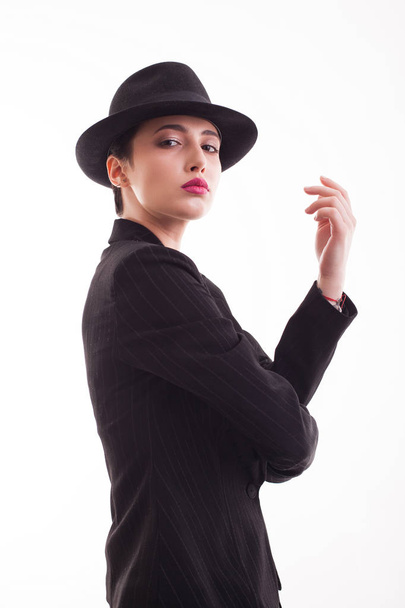 Caucasian beauty wearing a stylish hat posing in studio over white background in studio - Foto, immagini