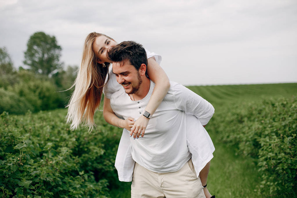 Beautiful couple spend time on a summer field - Photo, image