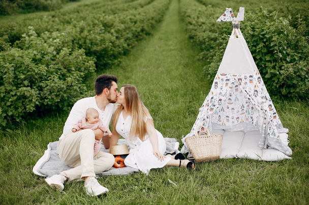 Cute family playing in a summer field - Foto, Imagen