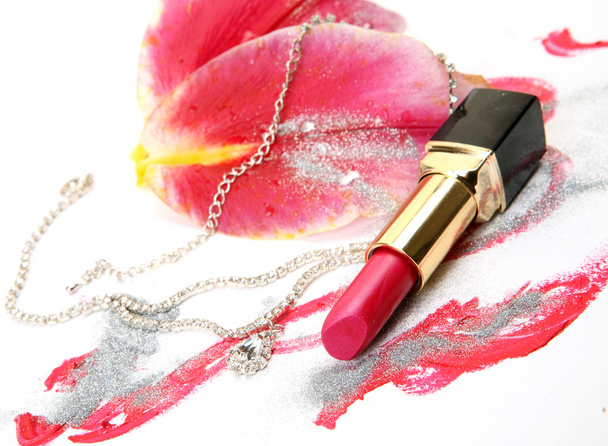 Lipstick and petals of a pink lily - Φωτογραφία, εικόνα