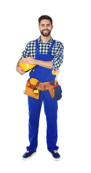 Full length portrait of construction worker with tool belt on white background - Фото, зображення