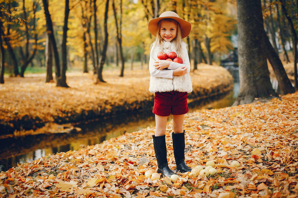 Cute little girl in a autumn park - 写真・画像