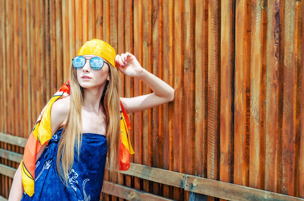 Young girl in a yellow bandana and large sunglasses portrait on  - Foto, Bild