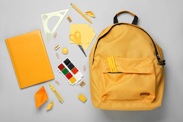 School backpack and stationery on light background - Foto, immagini