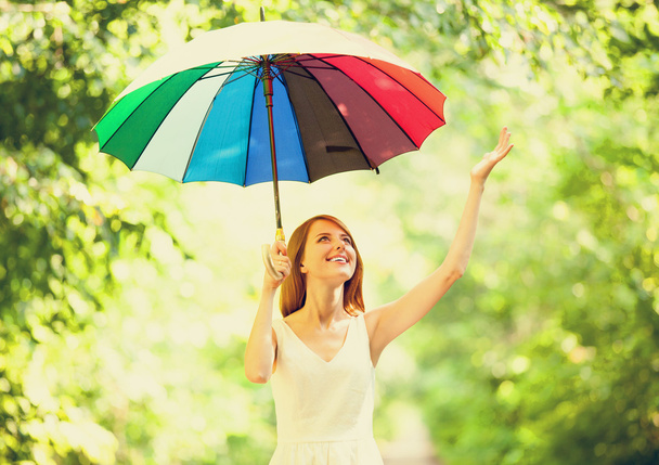 Redhead girl with umbrella at outdoor - Photo, Image