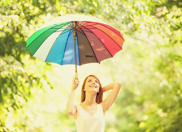 Redhead girl with umbrella at outdoor - Photo, Image