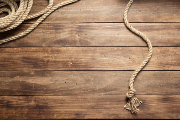 ship rope at wooden board background - Фото, изображение