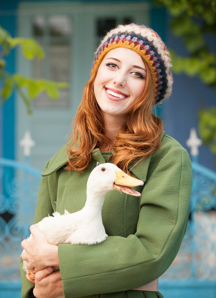 Redhead girl with duck at outdoor. - Photo, image