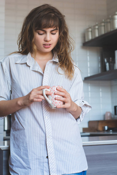 young woman drinking coffee at home - Fotoğraf, Görsel