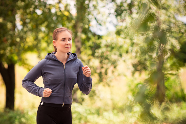 Runner woman jogging in nature outdoor - Фото, изображение