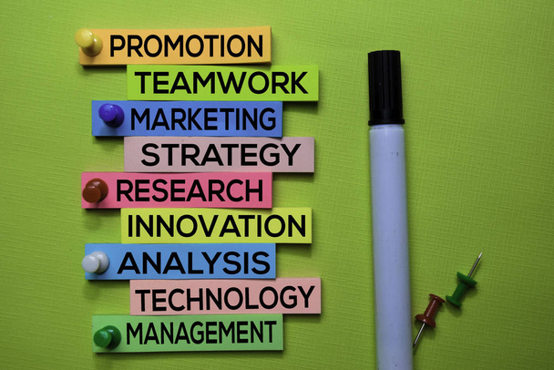 Promotion, Teamwork, Marketing, Strategy, Research, Innovation, Analysis, Technology, Management text on sticky notes isolated on green desk. Mechanism Strategy Concept - Photo, Image