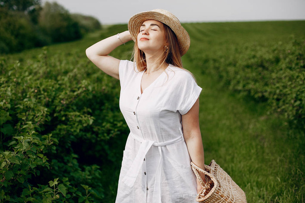 Elegant and stylish girl in a summer field - Φωτογραφία, εικόνα