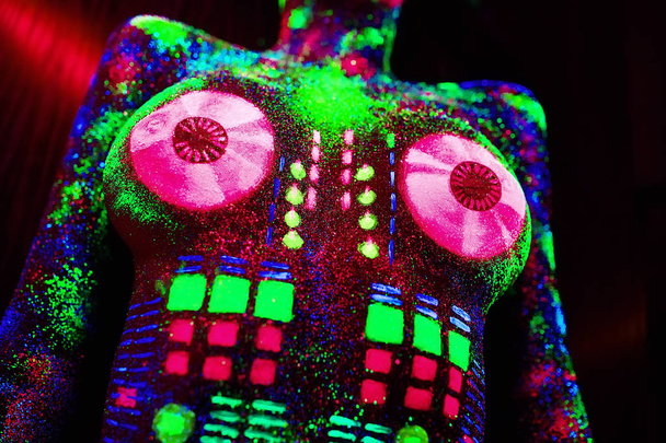 Concept. On the body of a girl painted DJ deck. Half-naked girl painted in UV colors - Фото, зображення