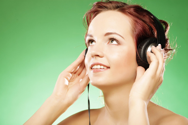 Woman with headphones listening to music - Фото, изображение