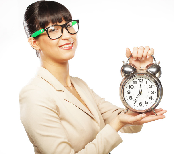 Businesswoman wearing glasses holding alarm clock - Photo, image