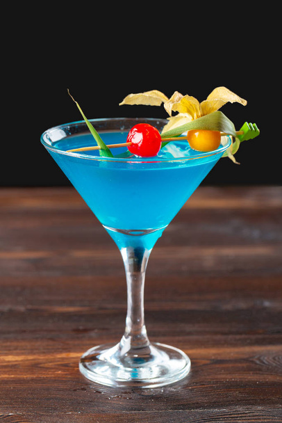 glass of delicious alcoholic cocktail on dark background - 写真・画像