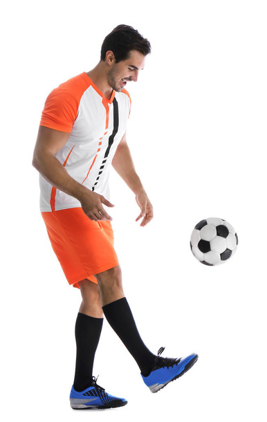 Young man playing football on white background - Foto, afbeelding