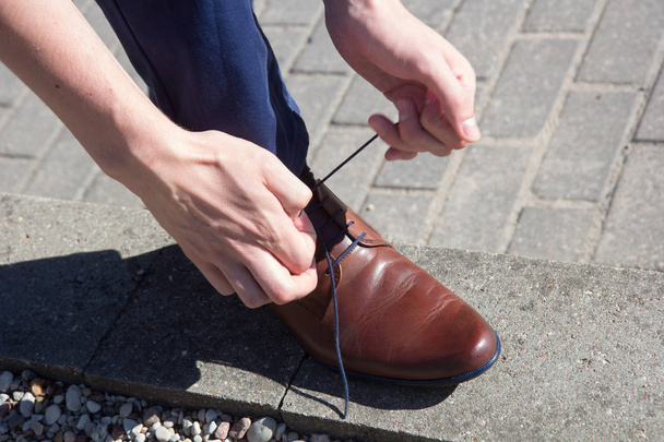 Man tying shoes laces - Photo, Image