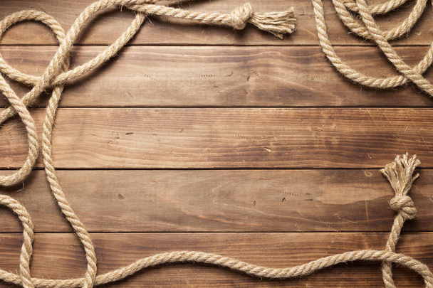 ship rope at wooden board background - Φωτογραφία, εικόνα