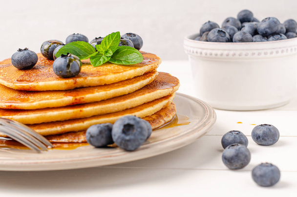 Stack of pancakes with fresh blueberry and caramel syrup. Top view - Foto, Imagen