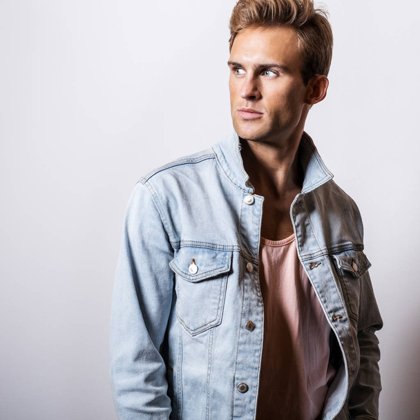 Handsome young man in jeans jacket pose in studio. - Photo, Image