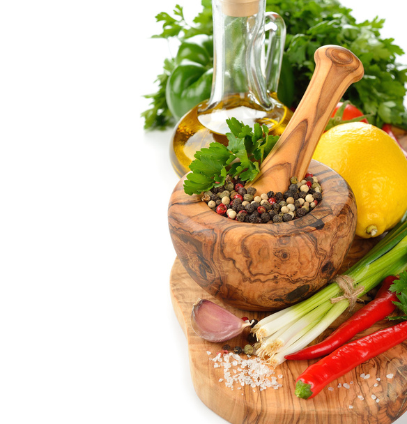 Spices, wooden mortar and vegetables - Фото, изображение