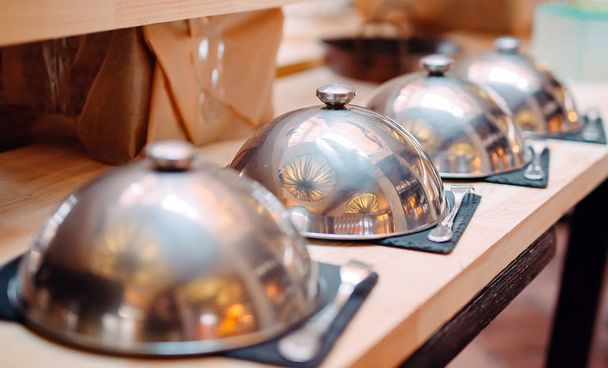 buffet in a restaurant or hotel. Metal dishes with caps. - Foto, Bild