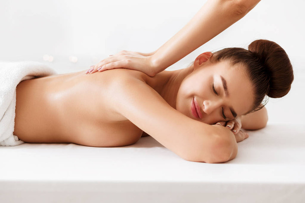Masseur doing back massage on woman body - Photo, image