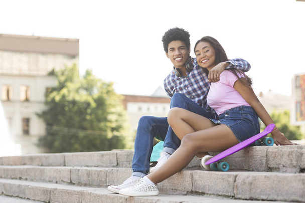 Couple of teenagers sitting on stairs posing to camera - Zdjęcie, obraz