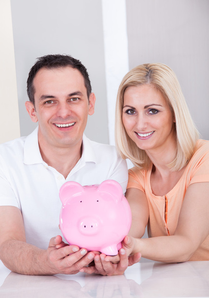 Happy Couple Holding Piggybank - Fotoğraf, Görsel