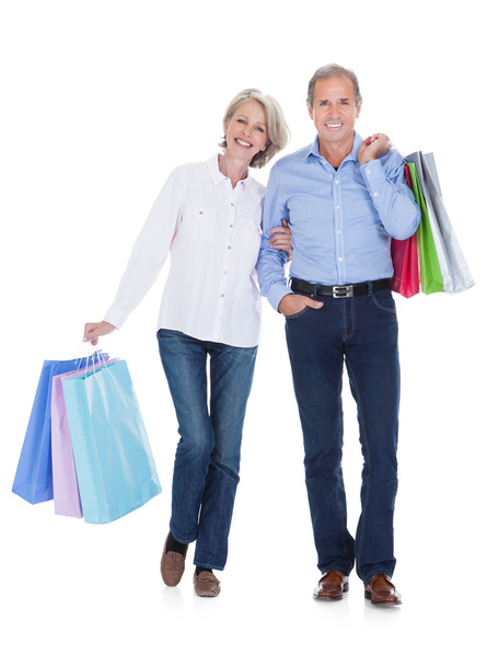 Mature Couple Holding Shopping Bags - Foto, imagen
