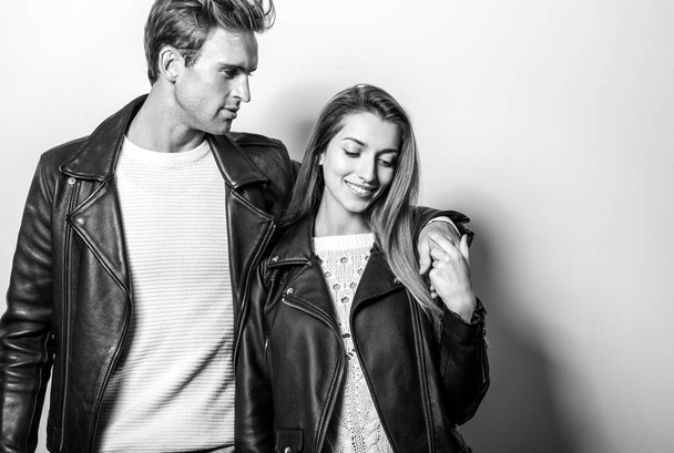Young beautiful couple in black leather jackets. Black-white portrait. - Foto, Imagen