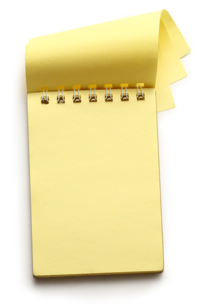 Bloc de notas amarillo abierto sobre blanco
 - Foto, Imagen