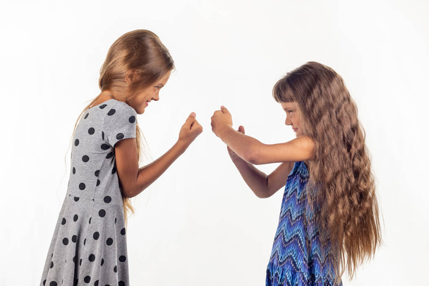 Two girls are fighting, studio white background - Photo, Image