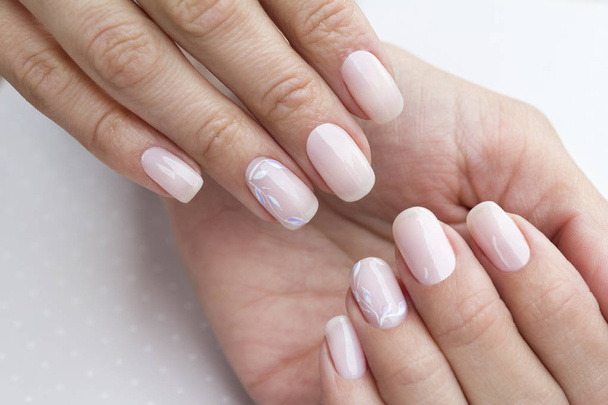 Beautiful groomed woman's hands with feminine nails on the light - Photo, Image