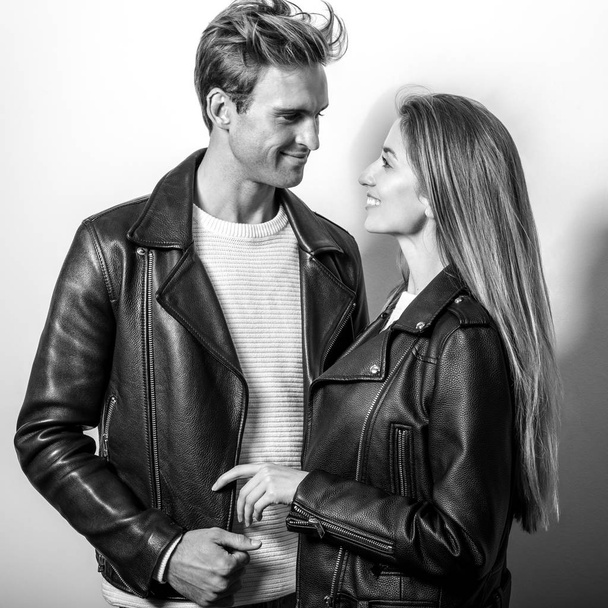 Young beautiful couple in black leather jackets. Black-white portrait. - Φωτογραφία, εικόνα